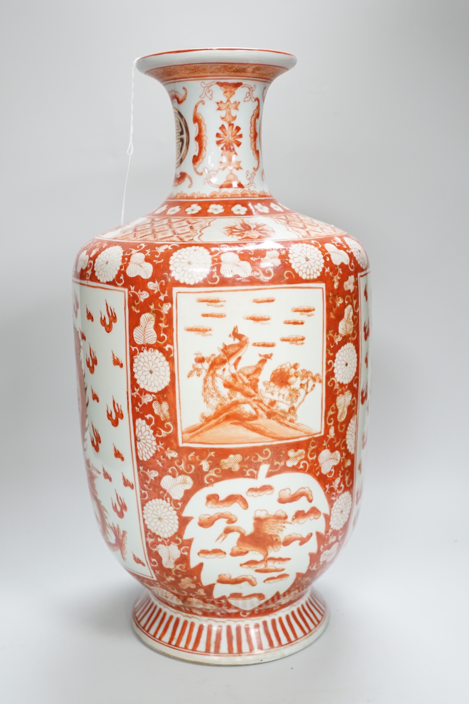 A Chinese iron red decorated ‘Dragon’ vase, a similar smaller pair of ‘Buddhist lion’ vases and a pair of black ground ‘goldfish’ vases, Republic period and later, tallest 42cm high